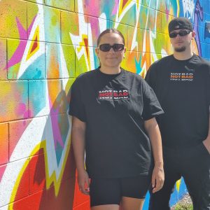 male and female models using not bad clothing Oversized TEE red and orange